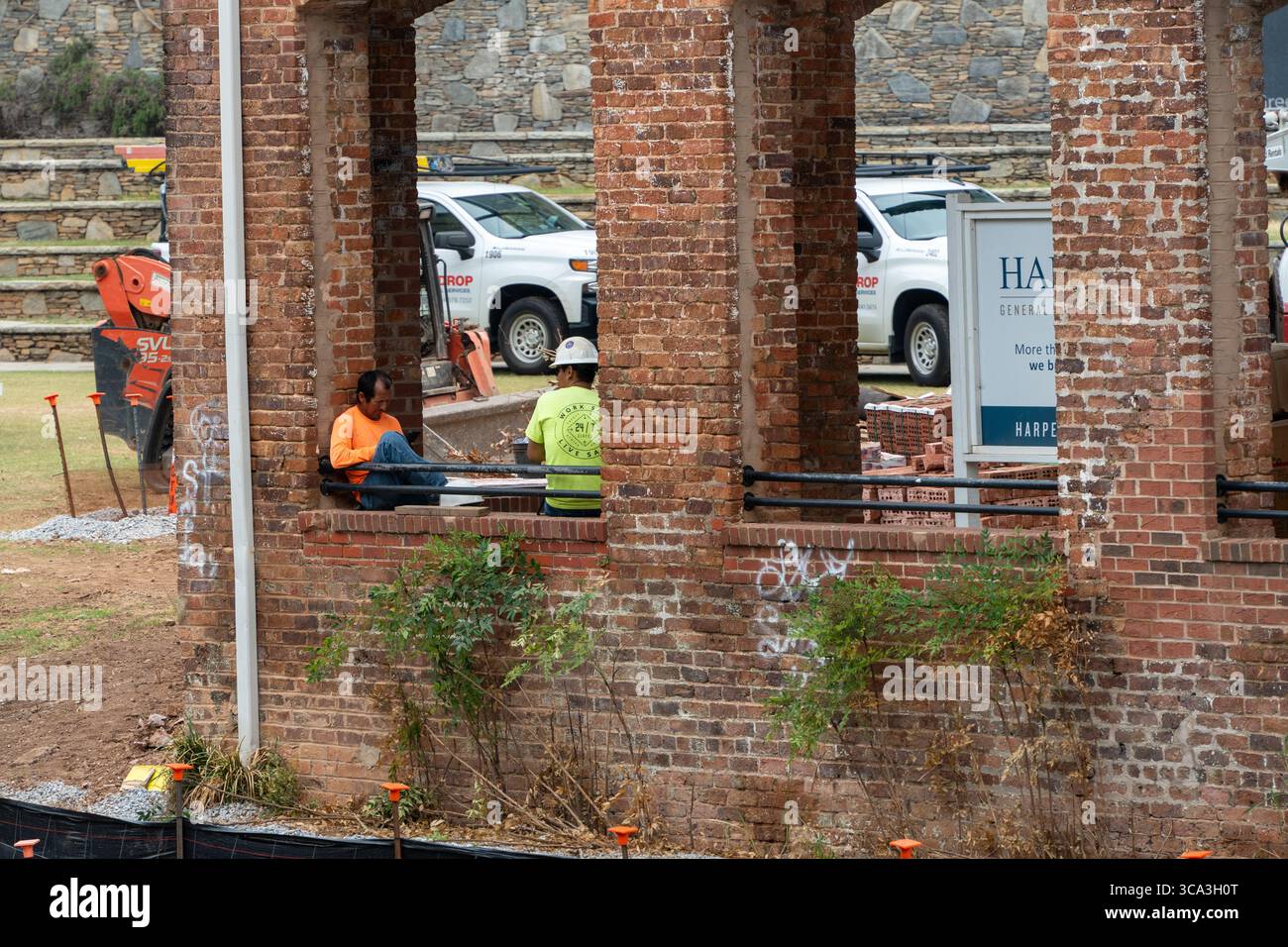 Greenville, SC - USA - luglio 30 2025 - i lavoratori edili si fermano nelle calde giornate umide di una mattina estiva Foto Stock