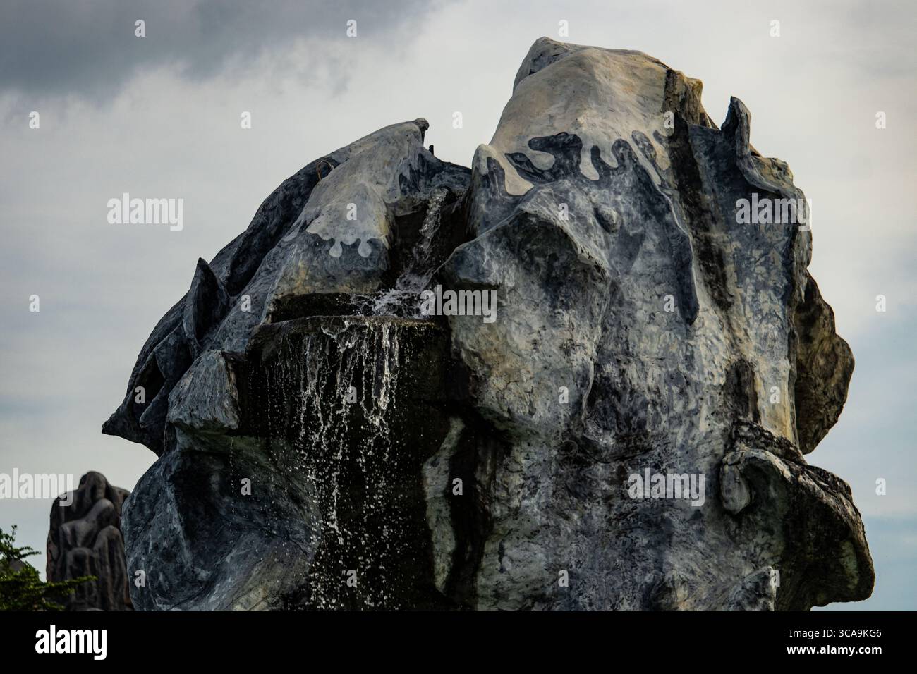 Fontana decorativa all'aperto con pietre d'imitazione Foto Stock