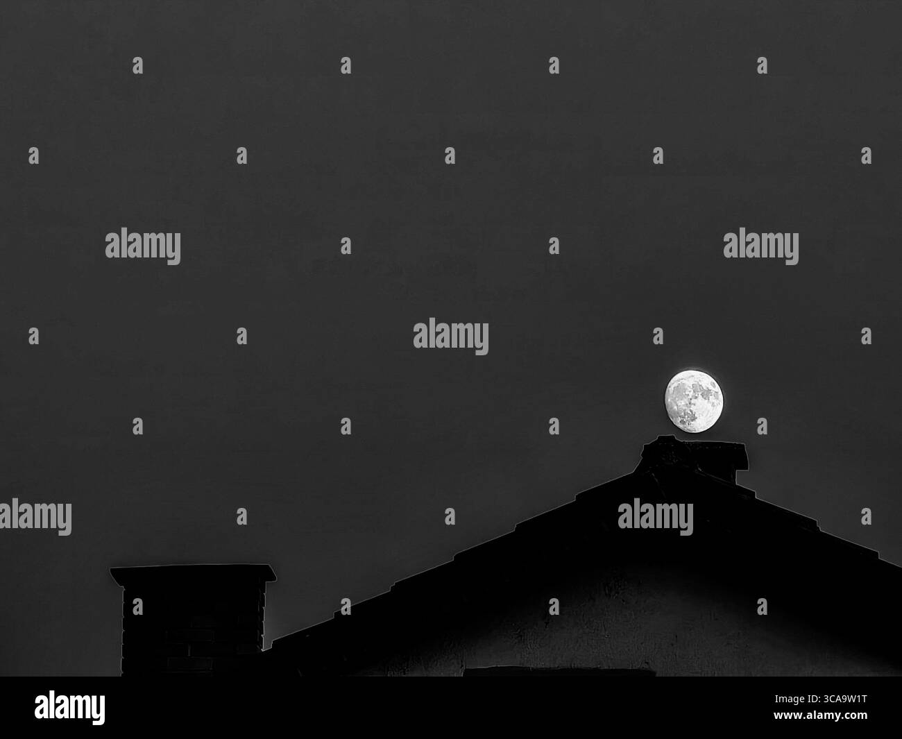 Moon Over the Chimney – quasi piena. Tonalità monocromatiche Foto Stock