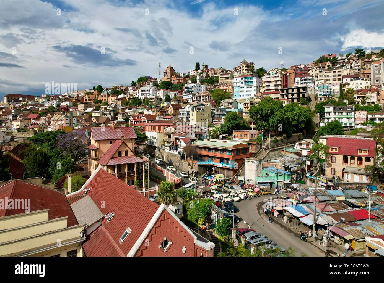 Bancarelle del mercato e Peugeoti parcheggiati sotto l'ascesa terrazzata di Ambohijatovo | Antananarivo | Madagascar | TNR Foto Stock