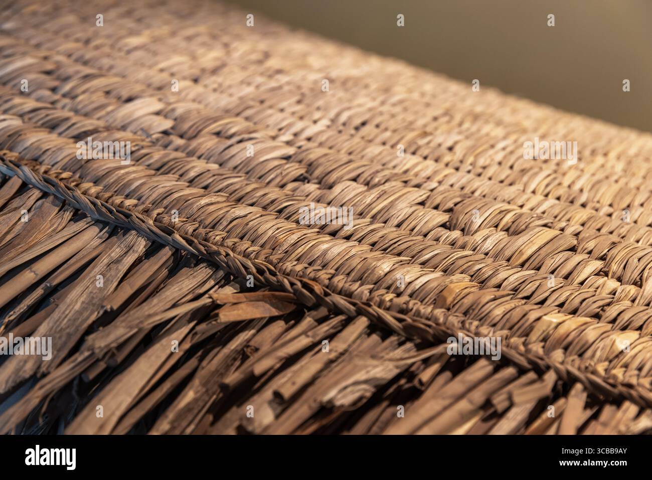 Vista dettagliata di una tradizionale superficie in paglia che mostra tecniche e texture intricate, mettendo in risalto l'artigianato culturale e la sustaina Foto Stock