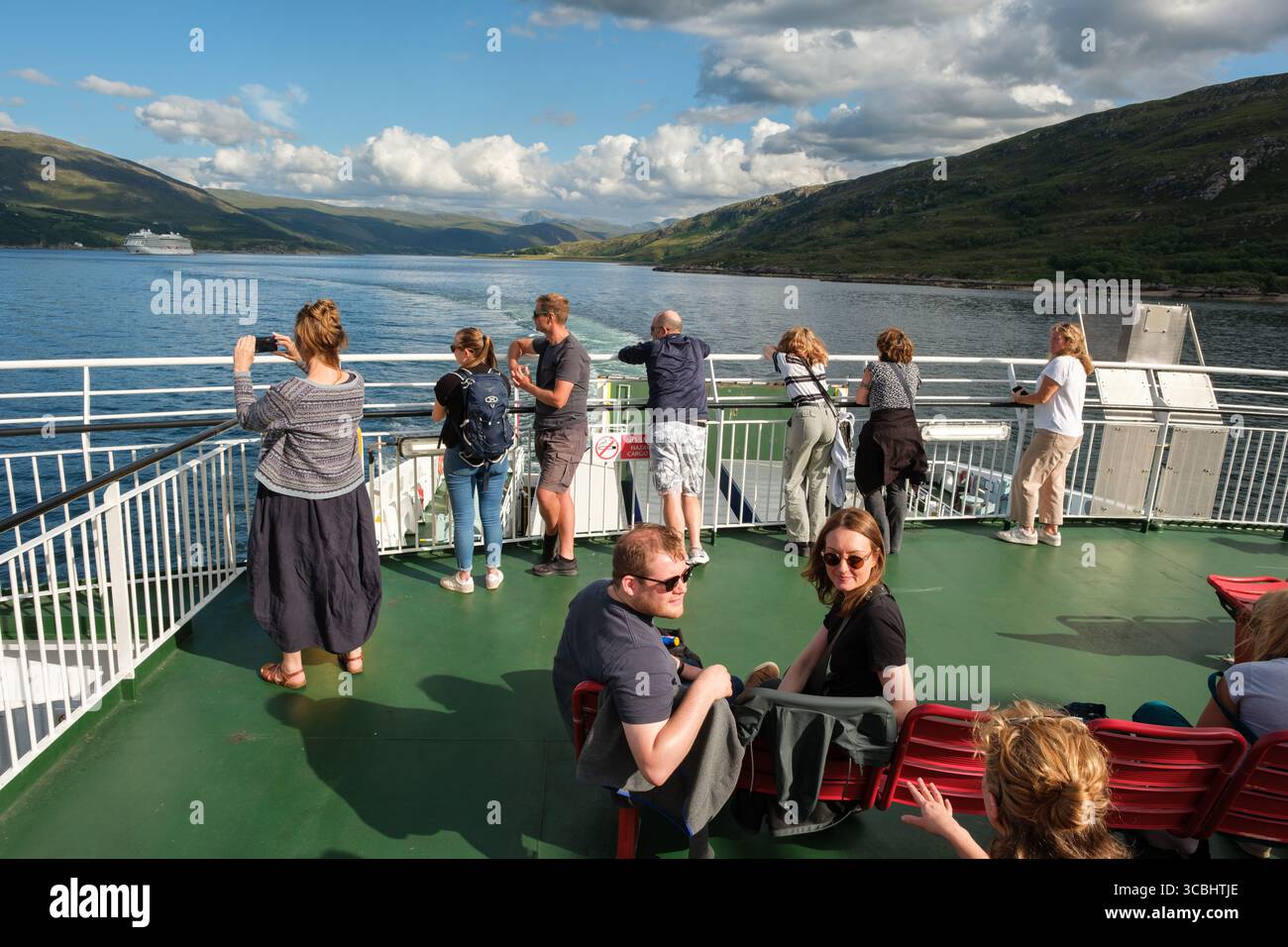 Le persone sul traghetto Loch Seaforth chiacchierano, fotografano e ammirano il paesaggio delle Highland a Loch Broom, nelle Highlands scozzesi, sulla rotta Ullapool-Stornoway. Foto Stock