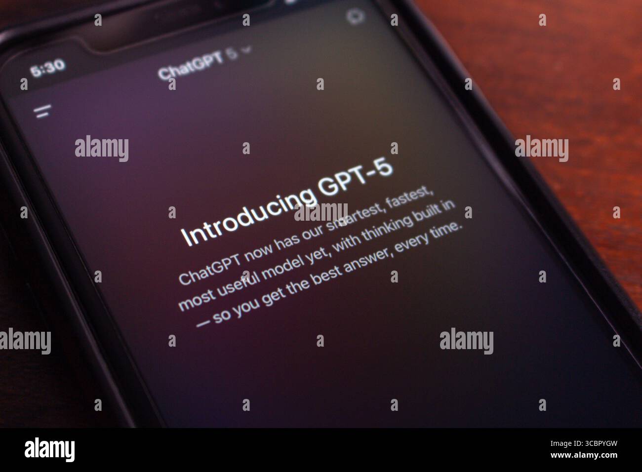 Primo piano di uno smartphone in modalità buia che mostra l'introduzione di GPT-5 nell'app ChatGPT, con funzionalità di intelligenza artificiale avanzate. Foto Stock