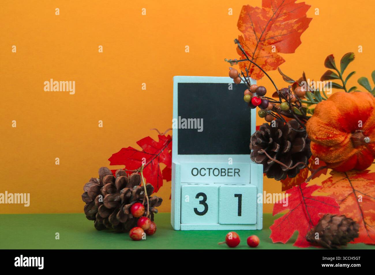 Calendario con la data "OTTOBRE 31" circondato da decorazioni autunnali. Foto Stock