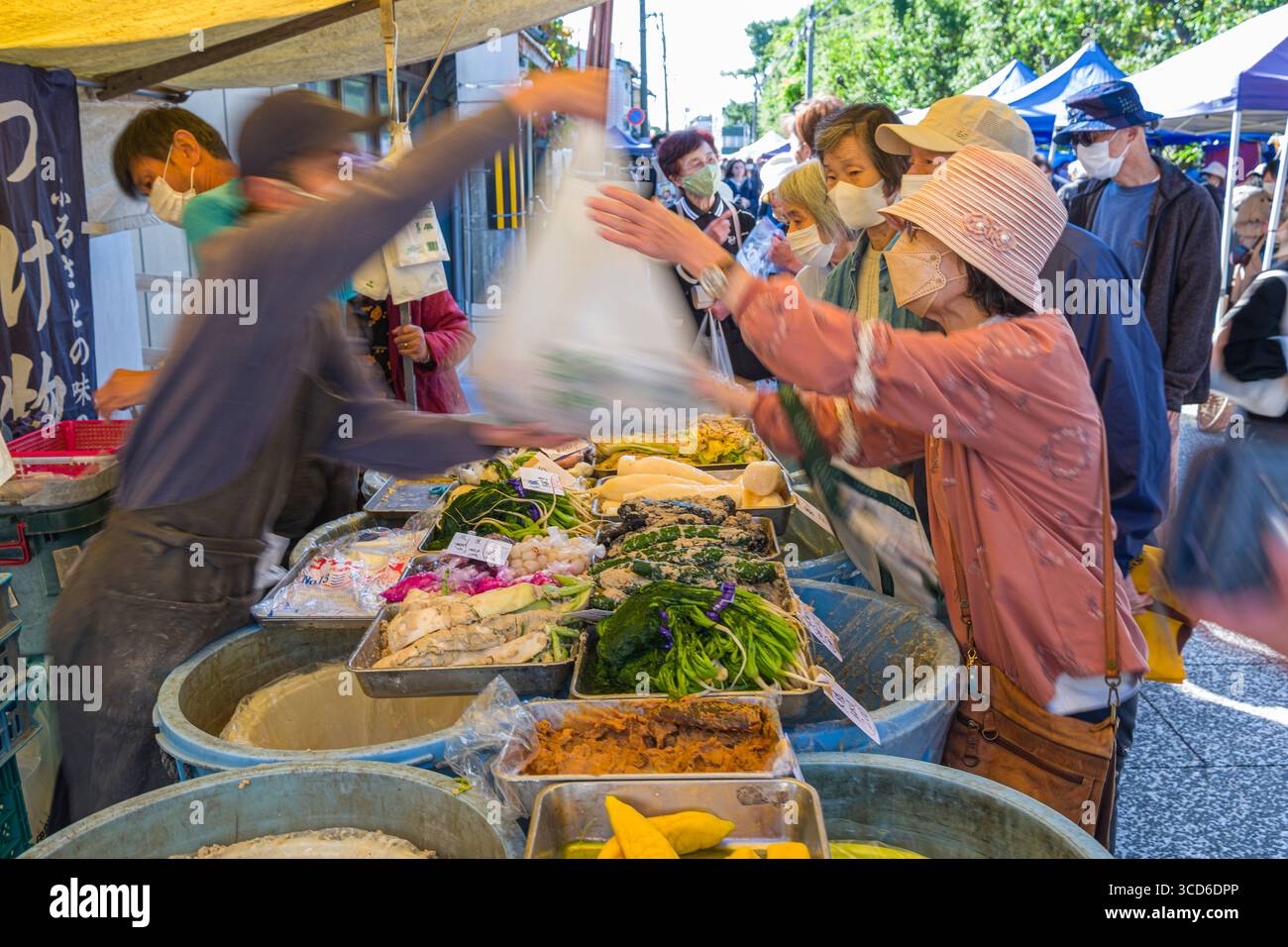 Persone che acquistano prodotti freschi per la vendita durante il mercato mensile delle pulci al santuario Tenmangu, Bakurocho, Kamigyo Ward, Kyoto, Kansai, Honshu, Giappone Foto Stock