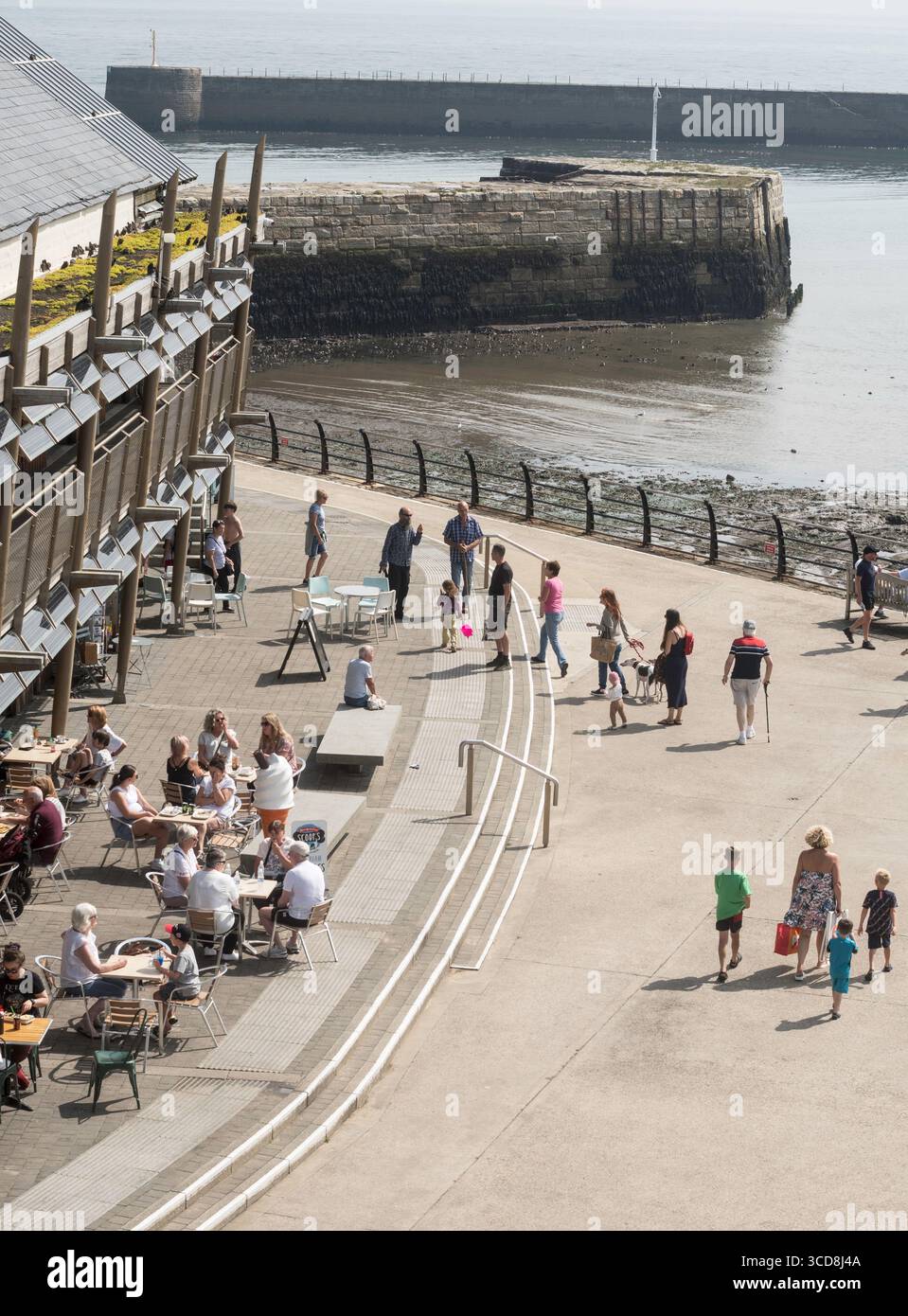 Persone sedute fuori dal caffè al porto di Seaham Foto Stock
