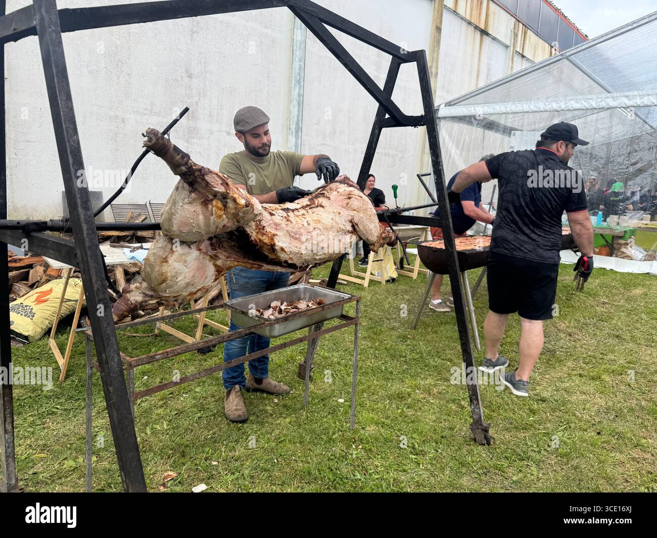 Arrosto di maiale allo spiedo come parte del pasto finale Trail Run Nordeste Real Priolo nelle Azzorre, Portogallo. - Immagine stock catturata con smartphone