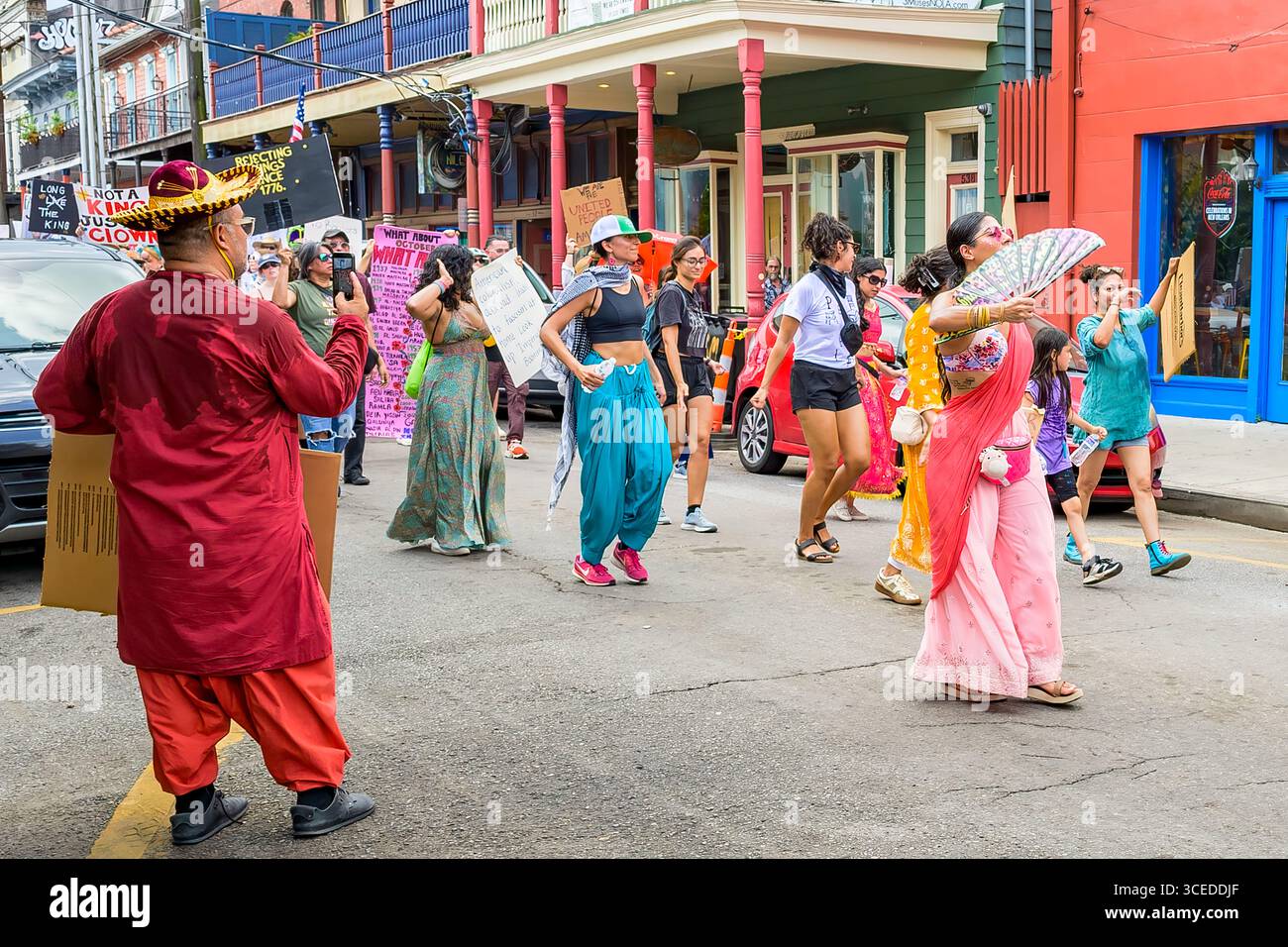 New Orleans, LOUISIANA, USA - 14 giugno 2025: Manifestanti anti anti Trump, tra cui donne indiane americane colorate, con cartelli, nella marcia No Kings in Frenchmen Street, nello storico quartiere di Marigny Foto Stock