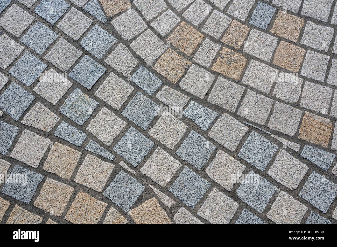 Texture con pavé in pietra in diagonale con piastrelle grigie e beige Foto Stock