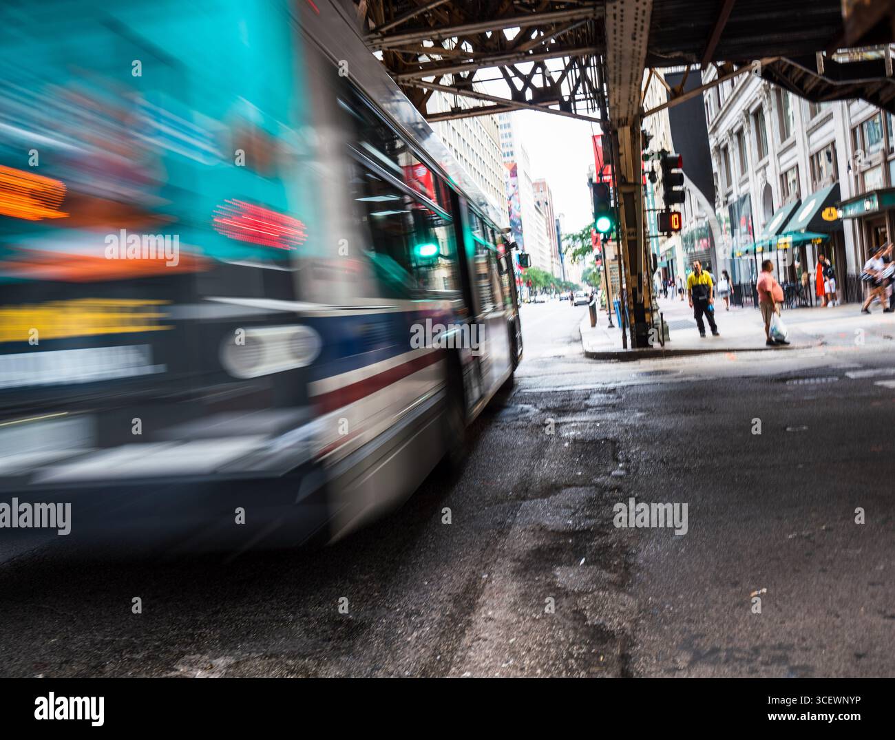 Un autobus della Chicago Transit Authority passa sotto i binari L nel centro di Chicago Foto Stock