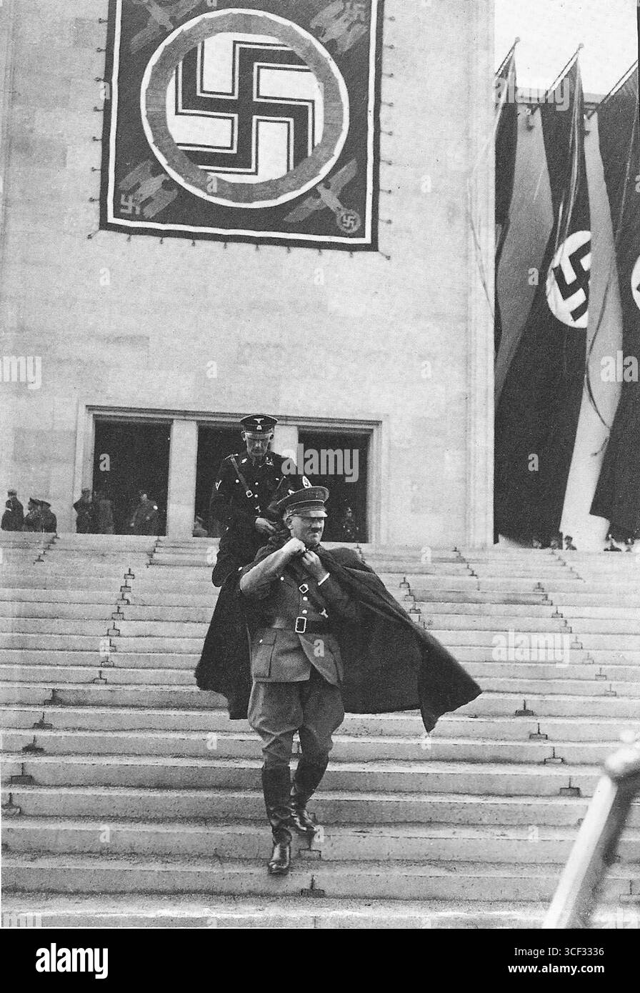 Adolf Hitler, vestito con l'uniforme del partito nazista e accompagnato da un ufficiale delle SS, è visto lasciare il Rally di Norimberga nel settembre 1936. Foto Stock