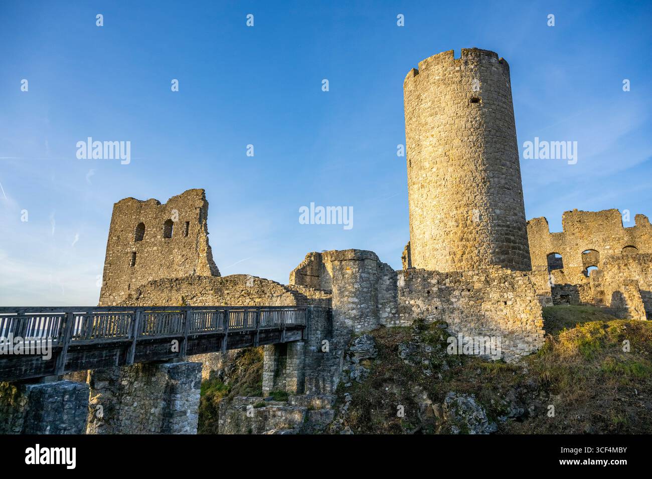 Possenti rovine del castello su una collina al sole della sera, circondate da paesaggi e alberi, rovine del castello di Wolfstein e Neumarkt nell'alto Palatinato Foto Stock