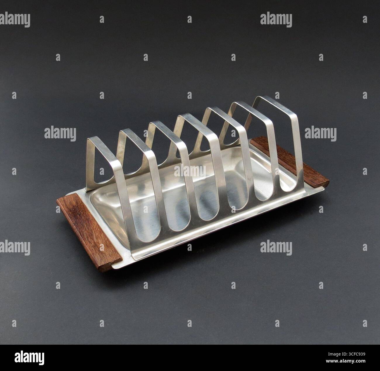 Una griglia per toast vintage in acciaio inossidabile moderna della metà del secolo progettata e prodotta in Danimarca negli anni '1960 Elegante design scandinavo modernista con manici in legno di teak. Foto Stock