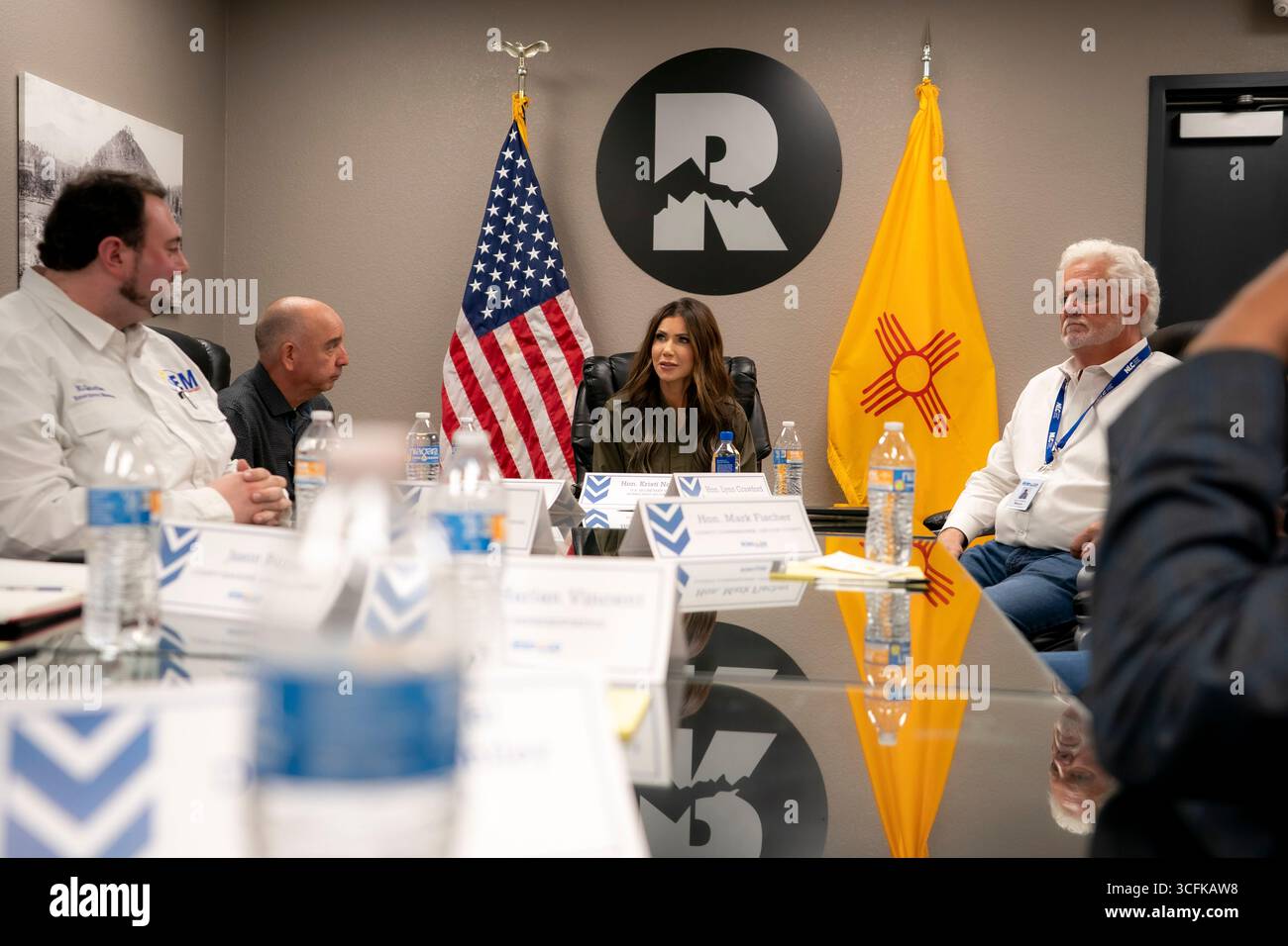 Il segretario del Dipartimento per la sicurezza interna (DHS) Kristi Noem ha viaggiato su un jet militare e poi su un elicottero fino al muro del confine meridionale degli Stati Uniti, dove ha in mano una foto - sotto la direzione del presidente Donald Trump - per dipingere il muro d'acciaio del confine nero a Santa Teresa, New Mexico. Noem è stato assistito da membri in uniforme degli agenti della dogana e della protezione delle frontiere degli Stati Uniti. La vernice nera doveva raccogliere l’energia del sole per rendere l’acciaio del muro più caldo al tatto – quindi più difficile per i clandestini scalare. La vernice, tuttavia, veniva applicata solo sul lato statunitense del muro di confine. Foto Stock