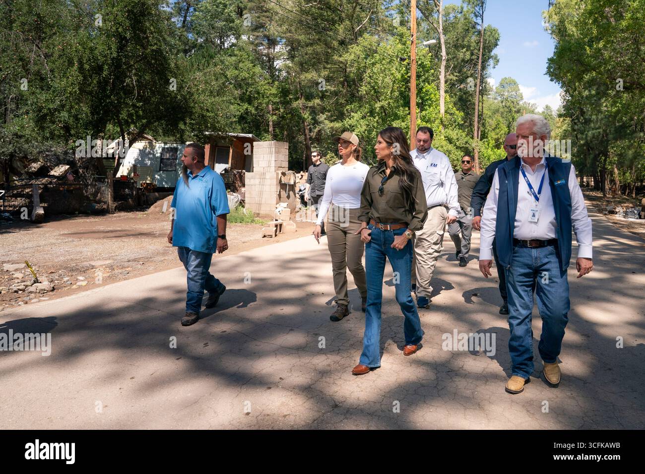 Il segretario del Dipartimento per la sicurezza interna (DHS) Kristi Noem ha viaggiato su un jet militare e poi su un elicottero fino al muro del confine meridionale degli Stati Uniti, dove ha in mano una foto - sotto la direzione del presidente Donald Trump - per dipingere il muro d'acciaio del confine nero a Santa Teresa, New Mexico. Noem è stato assistito da membri in uniforme degli agenti della dogana e della protezione delle frontiere degli Stati Uniti. La vernice nera doveva raccogliere l’energia del sole per rendere l’acciaio del muro più caldo al tatto – quindi più difficile per i clandestini scalare. La vernice, tuttavia, veniva applicata solo sul lato statunitense del muro di confine. Foto Stock