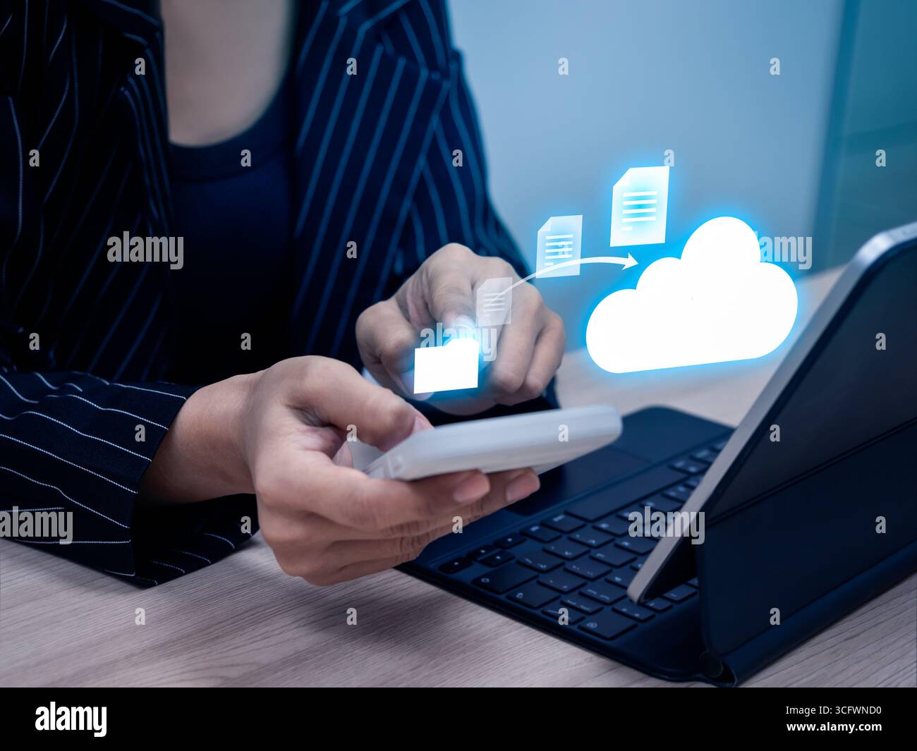 Donna d'affari che utilizza smartphone e tablet per caricare documenti su storage cloud, concetto di tecnologia cloud, trasferimento sicuro dei dati, condivisione di file e di Foto Stock