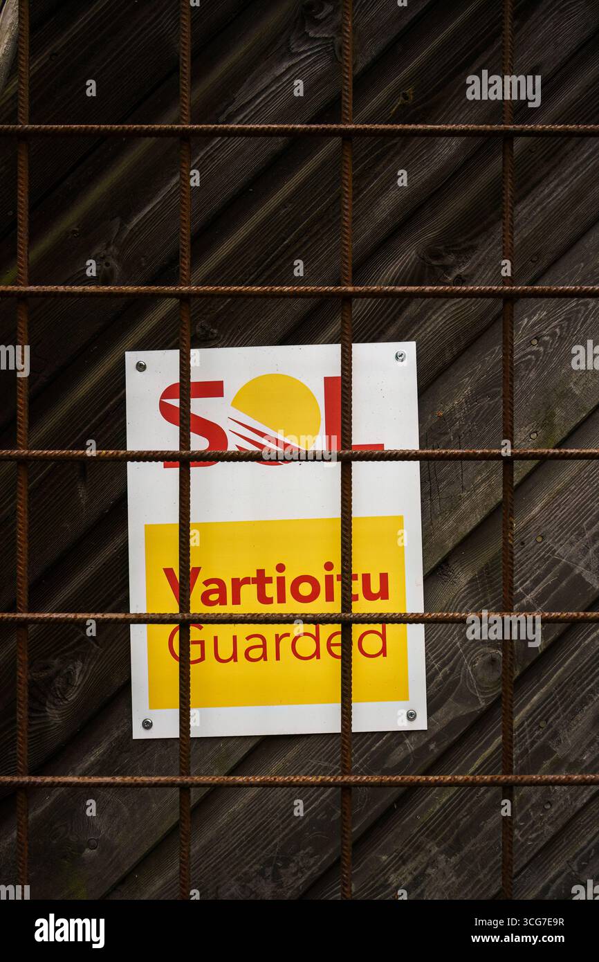 Nurmijärvi, Finlandia. 19 giugno 2025 - segnale di servizio pulizia SOL su una porta in legno dietro la griglia in metallo per armature Foto Stock