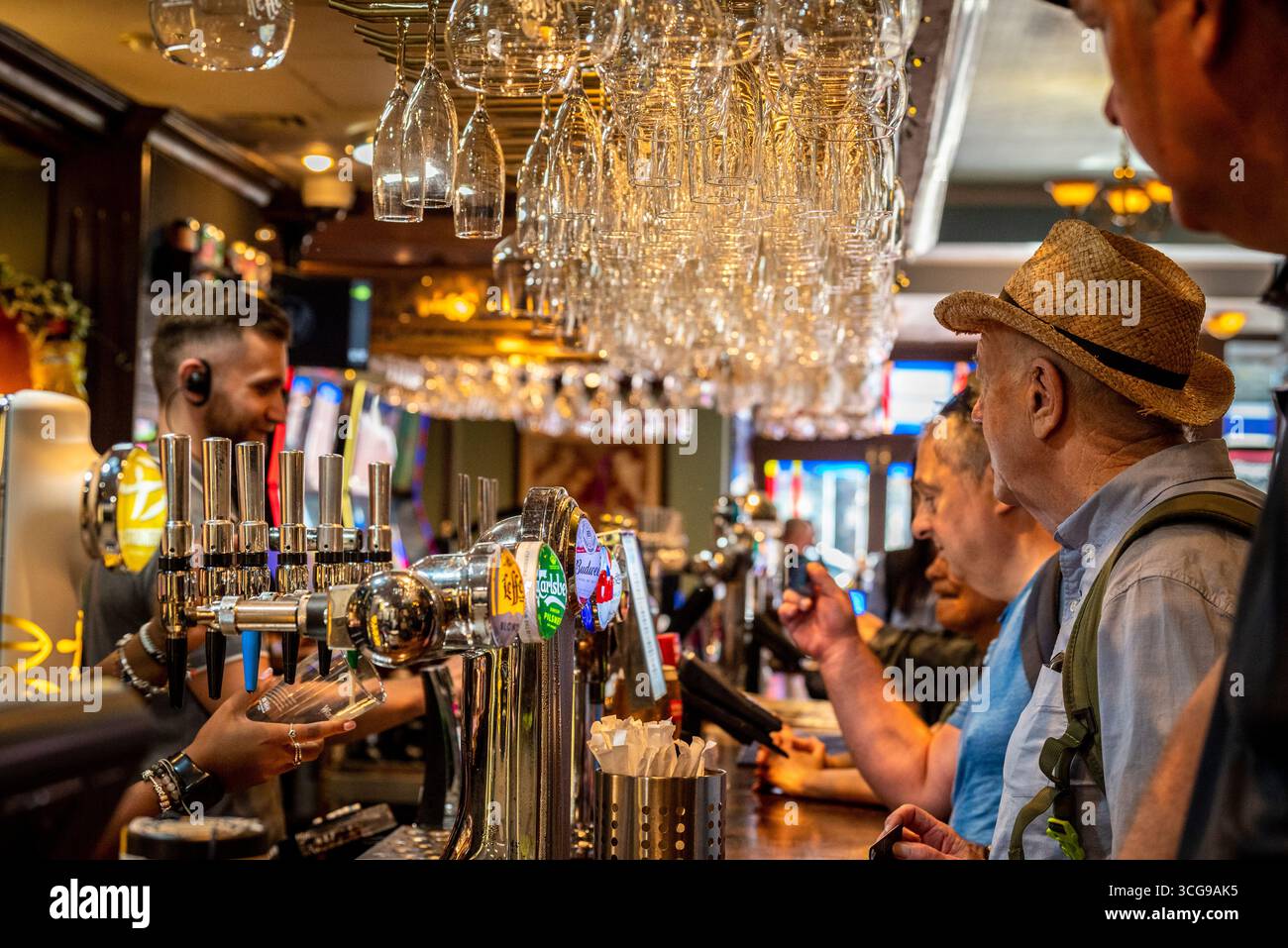 Persone che acquistano bevande al bar in un tradizionale pub inglese, Londra, Inghilterra, Regno Unito Foto Stock