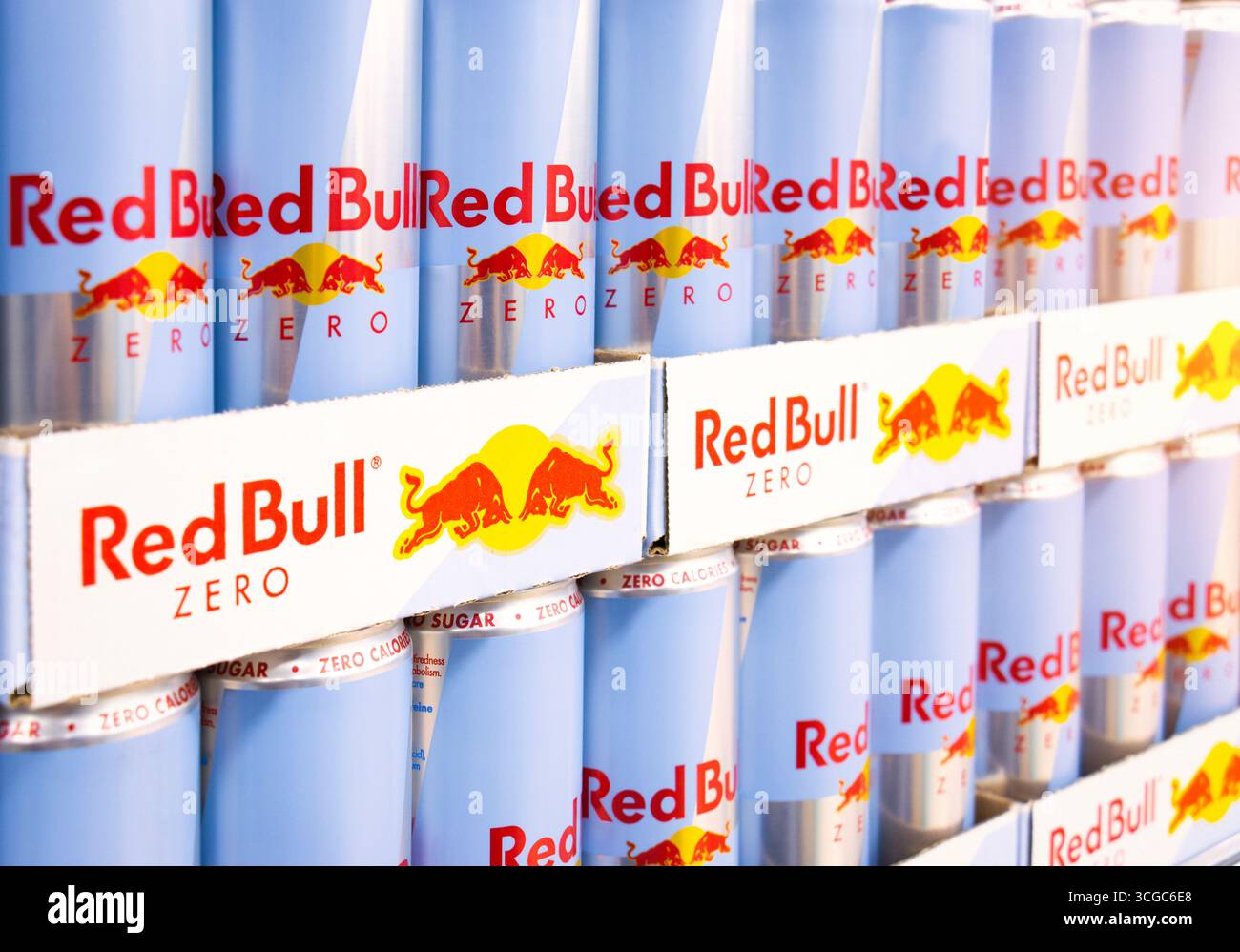 Bevanda energetica Red Bull Zero. Lattine con logo di bevande ad alta caffeina in vendita. Il marchio di bevande energetiche più popolare al mondo disponibile su scaffali di un negozio. Foto Stock