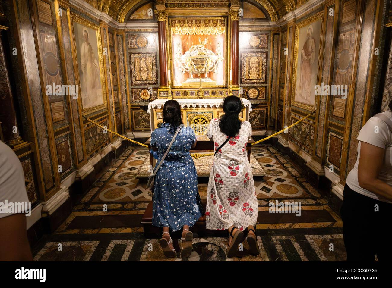 Le donne pregano in ginocchio di fronte alla "Sacra culla", una delle reliquie trovate sotto l'altare maggiore della Basilica di Santa Maria maggiore. L'anno giubilare 2025 proclamato da Papa Francesco sotto il tema "pellegrini della speranza", cerca di trasmettere un messaggio di speranza a un mondo segnato dalla guerra e dalla crisi. I fedeli sono chiamati al rinnovamento spirituale con particolare attenzione alla solidarietà e alla carità verso gli altri. Secondo la tradizione cristiana, i pellegrini possono ottenere un'indulgenza plenaria attraverso viaggi a Roma, atti di carità e passando attraverso una delle quattro "porte sante" della città. Foto Stock