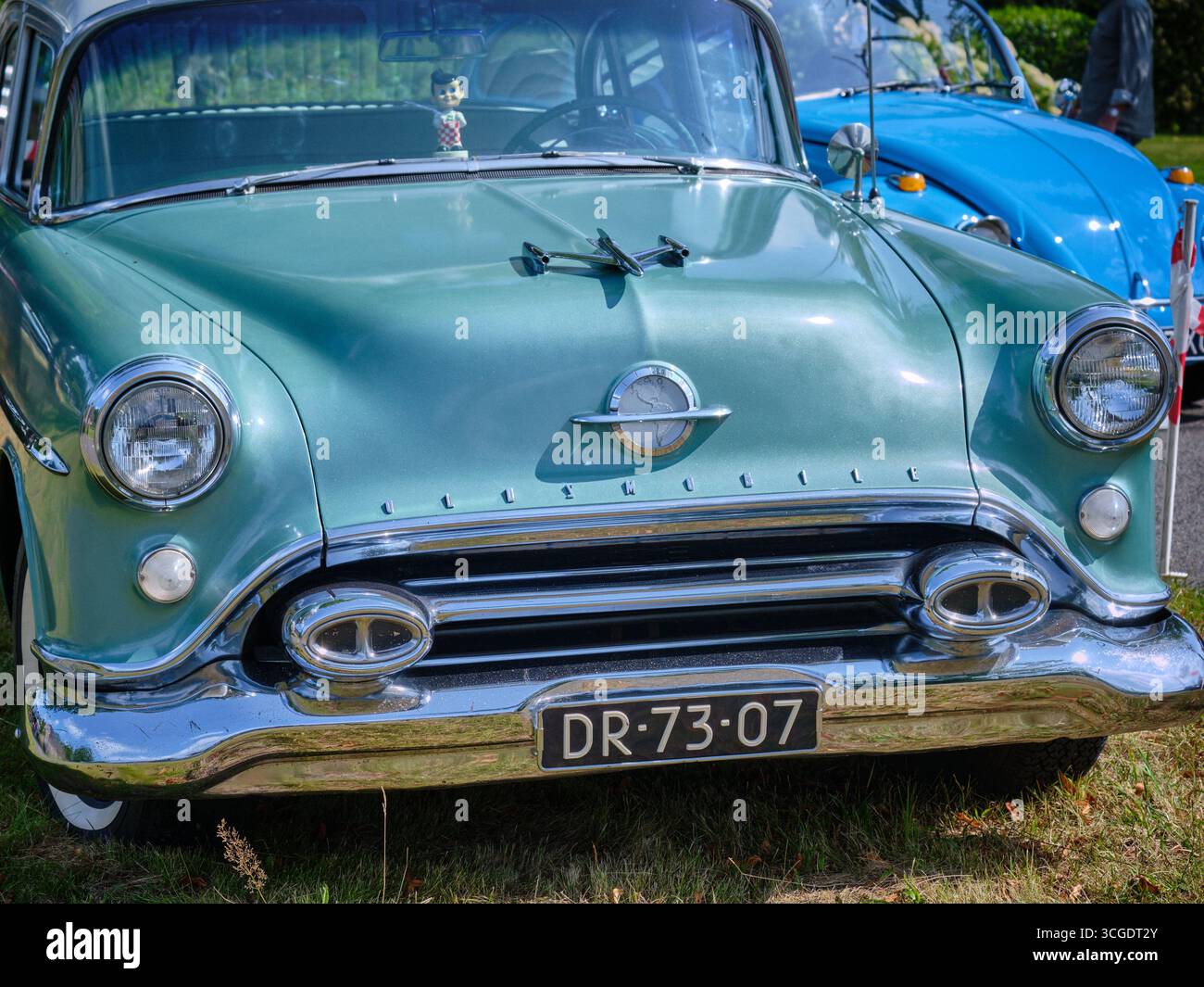 17 agosto 2024 - Ruinerwold-Netherlands: Davanti a una classica Oldsmobile 88 verde menta con griglia cromata, ornamento del cofano e fari rotondi a dispari Foto Stock
