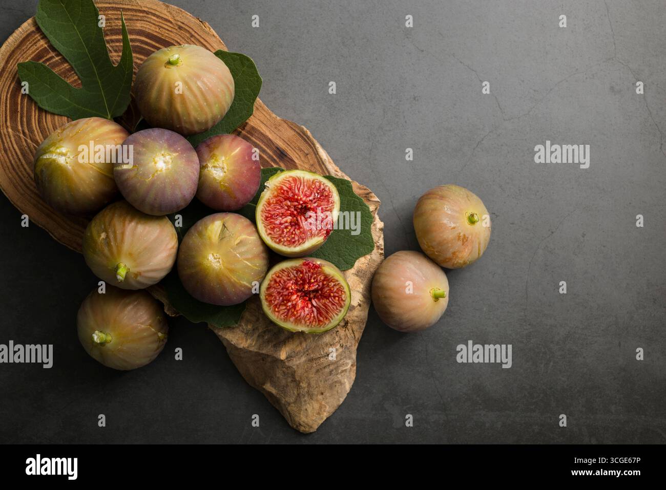 Fichi freschi posti sopra il tagliere di legno. Foto Stock