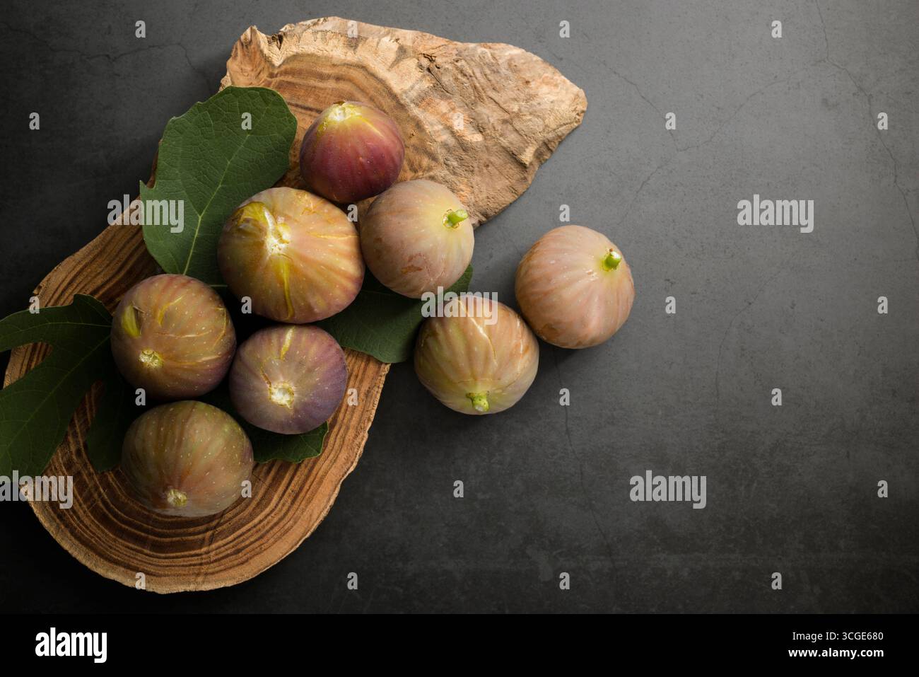 Fichi freschi posti sopra il tagliere di legno. Foto Stock