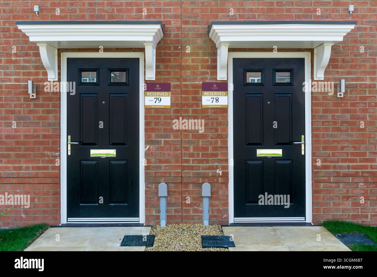 Porte d'ingresso di due nuove case adiacenti in vendita con cartelli riservati a South Wootton, alla periferia di King's Lynn, Norfolk. Foto Stock Porte d'ingresso di due nuove case adiacenti in vendita con cartelli riservati a South Wootton, alla periferia di King's Lynn, Norfolk. Foto Stock
