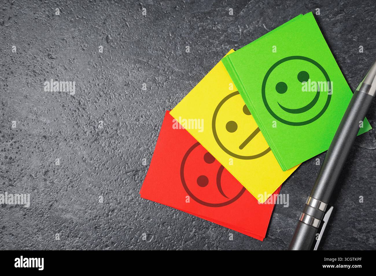 Feedback sulla soddisfazione del servizio clienti di qualità aziendale, valutazione e concetto di sondaggio con simbolo e icona di emoticon e soddisfazione sulle note cartacee. Foto Stock