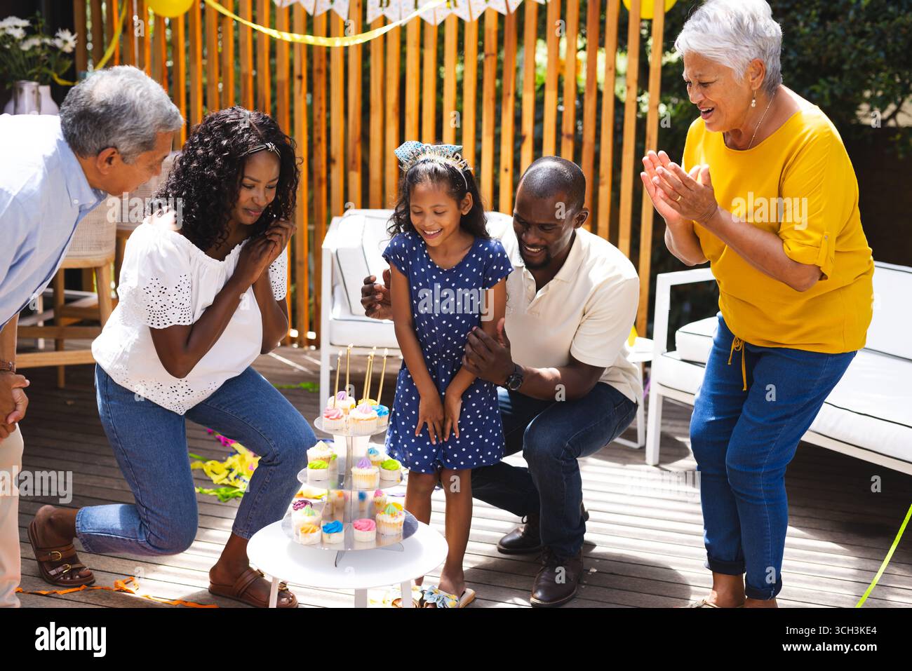 Alla festa, buona riunione di famiglia, festeggiando il compleanno con cupcake, sorridendo e applaudendo Foto Stock