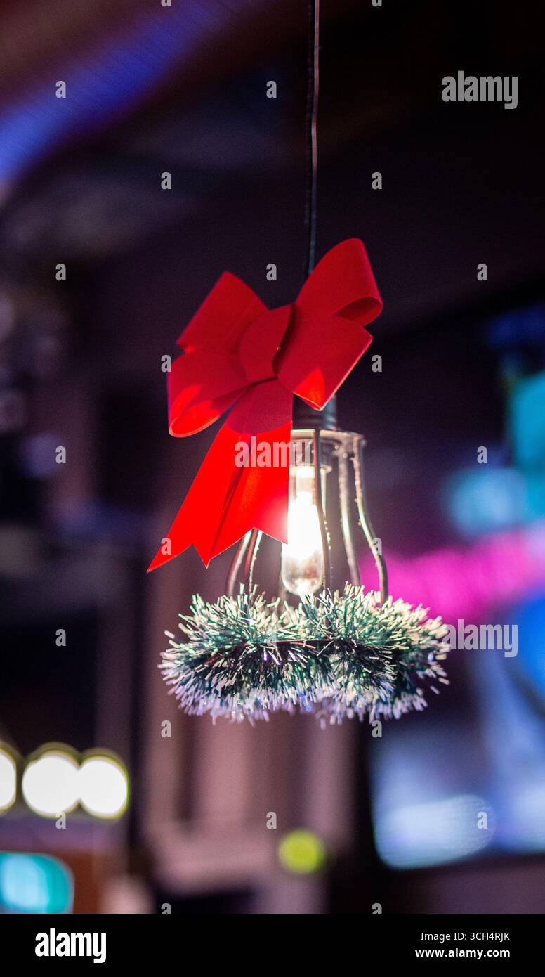 Luce da bar decorata per Natale con nastro rosso e ghirlanda Foto Stock