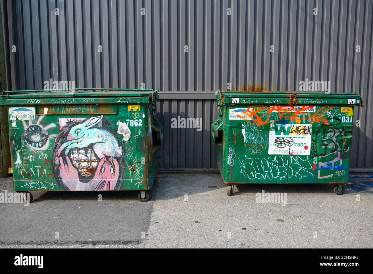 Bidoni della spazzatura contrassegnati lungo Astro Alley a Vancouver, British Columbia. Foto Stock