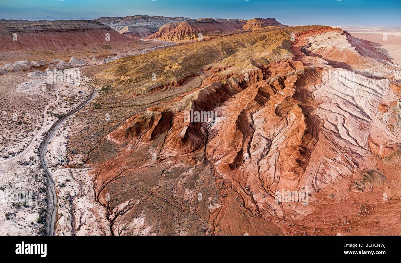 Prospettiva aerea mozzafiato che mostra le vivaci sfumature e gli intricati motivi delle formazioni di arenaria erose nell'aspro deserto Foto Stock