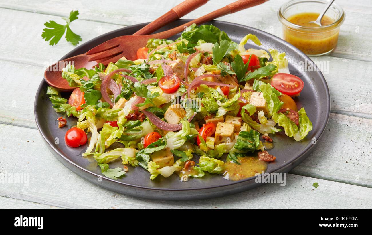 Insalata di tofu con salsa di senape e pomodori ciliegini Foto Stock