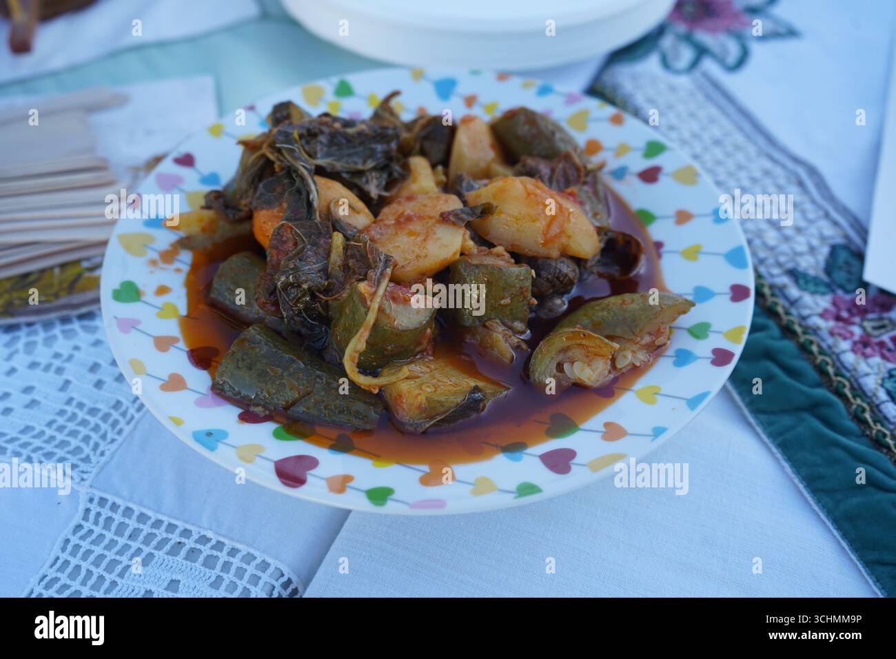 Primo piano di un piatto cretese con lumache, zucchine, patate e verdure in salsa di pomodoro. Gastronomia cretese, cucina greca, dieta mediterranea. Foto Stock