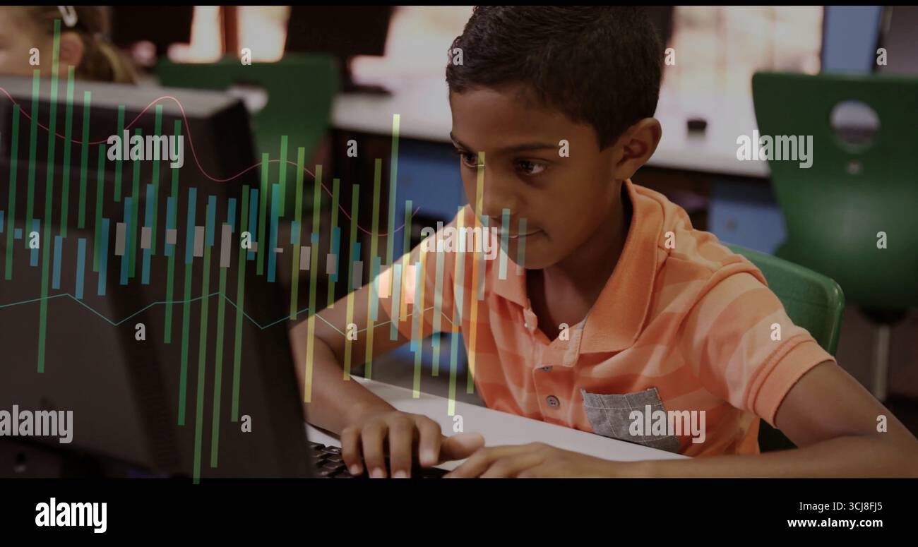 Tipizzazione dello studente in polo a strisce arancioni concentrandosi sul monitor da tavolo nel laboratorio scolastico, con tastiera Foto Stock