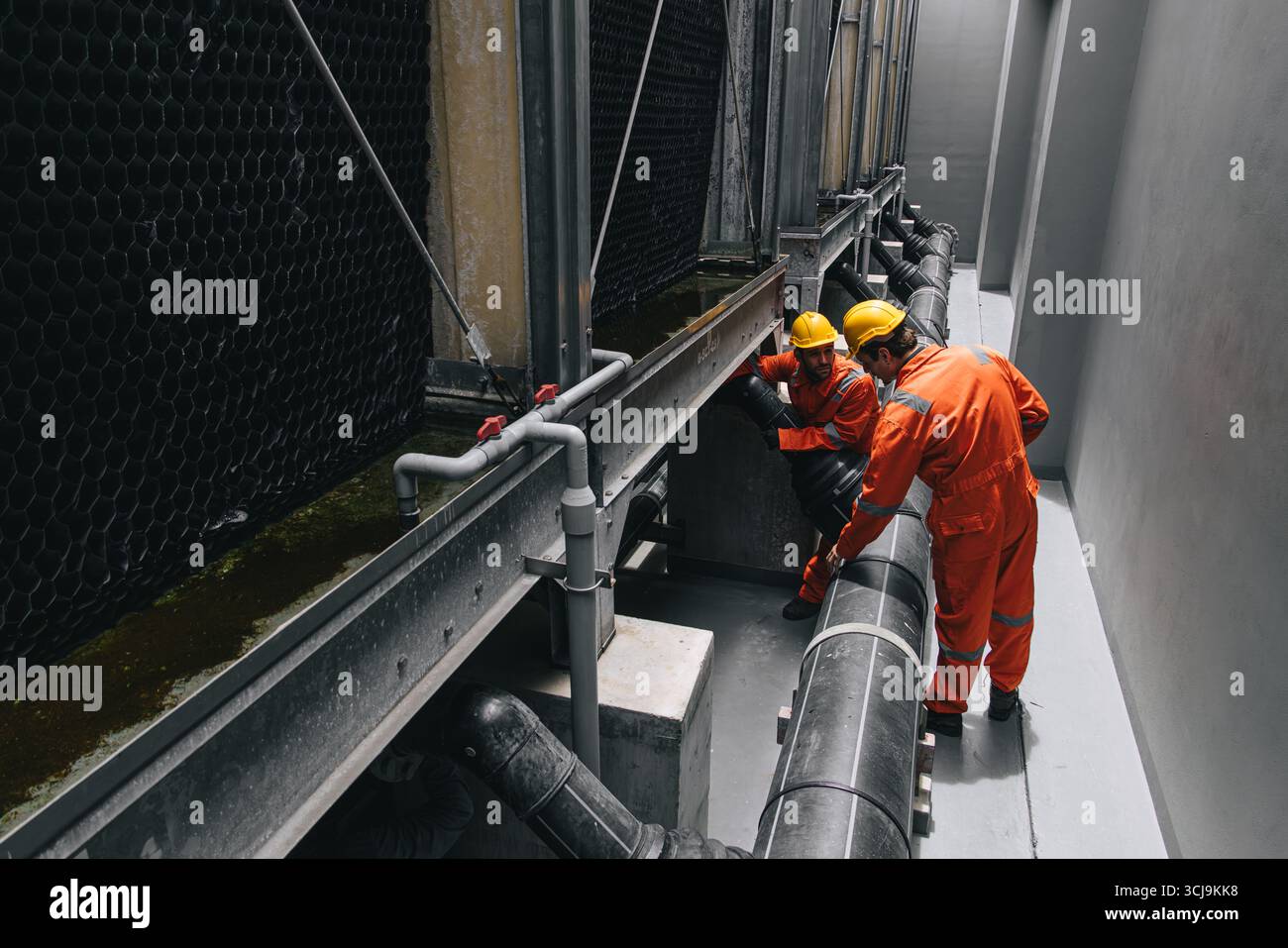 Due ingegneri professionisti maschio di servizio di squadra manutenzione, sistema di valvole per tubi dell'acqua per l'industria dei lavoratori Foto Stock