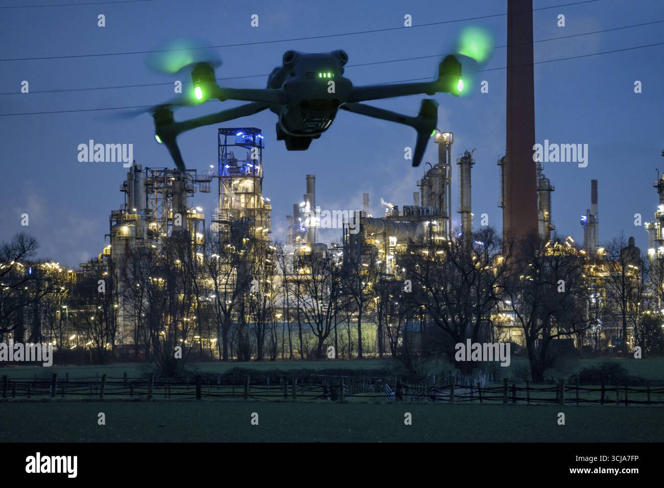 Immagine simbolica, fotomontaggio, ricognizione, spionaggio con i droni in impianti industriali, infrastrutture critiche, drone vola verso una comp industriale Foto Stock