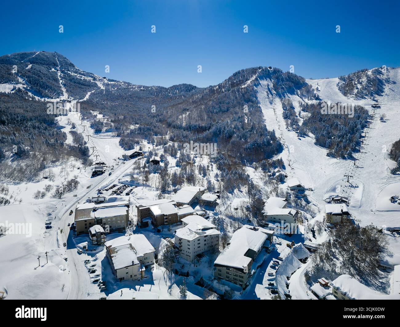 Luminoso giorno d'inverno sul monte Yokoteyama innevato e sulla zona sciistica di Nagano Foto Stock
