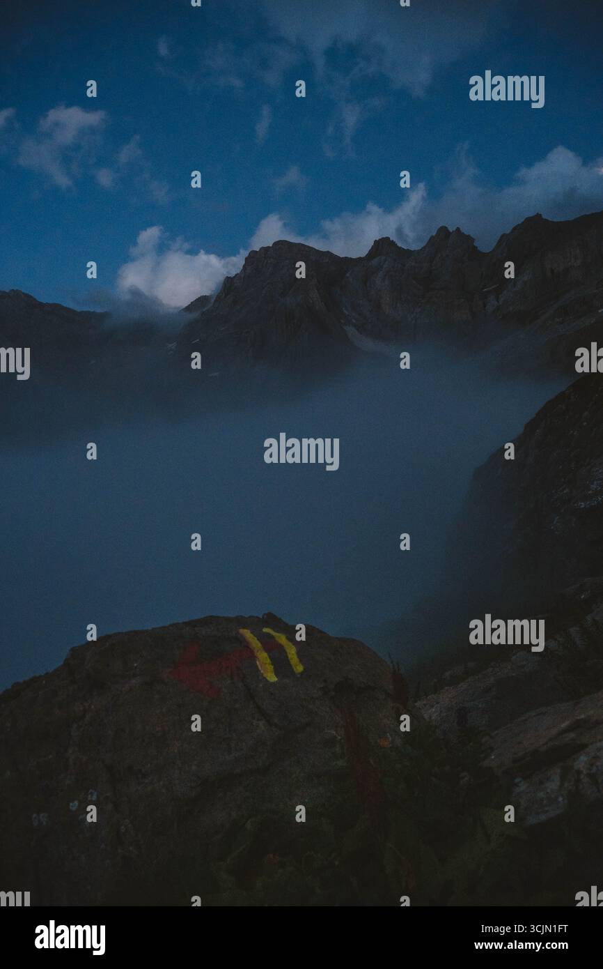 Una freccia rossa che indica il percorso escursionistico Foto Stock