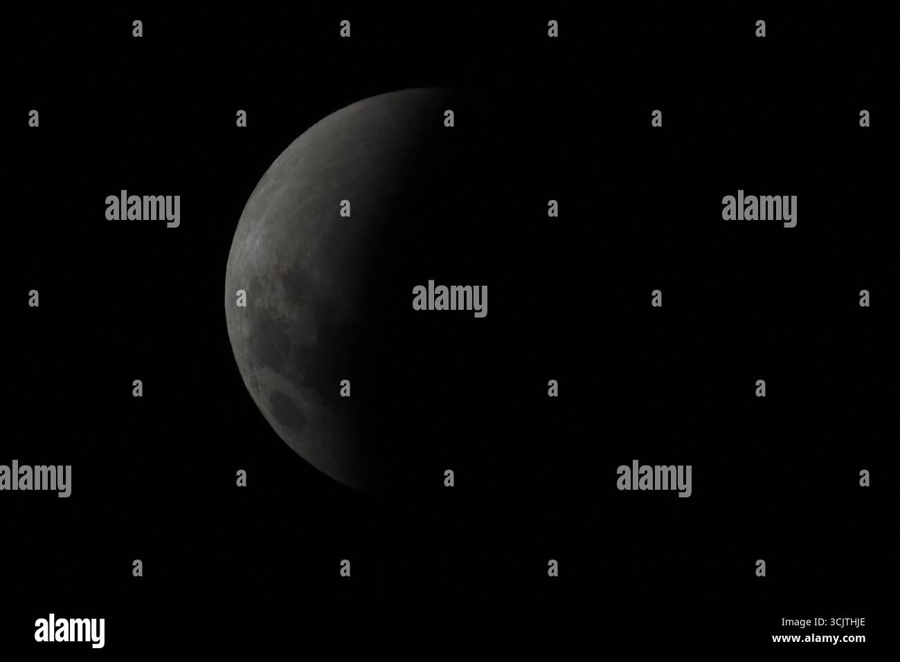 Melbourne, Victoria, Australia. 8 settembre 2025. La luna piena ritorna alla fase di eclissi parziale dopo la sua eclissi totale durante il fenomeno dell'eclissi lunare totale della Luna di sangue come visto a Melbourne City, Victoria. La luna piena dipinta di rosso è vista come la seconda eclissi lunare totale dell'anno in cui la luna si trova in profondità nella parte più oscura della Terra dell'ombra del nostro pianeta, creando una drammatica ''luna di sangue'' Un'eclissi lunare totale della Luna di sangue è stata visibile il 7/8 settembre 2025. Osservatori con sede in Pakistan, India, Cina, Russia, Australia e nuova Zelanda, Africa orientale e nelle regioni circostanti centr Foto Stock