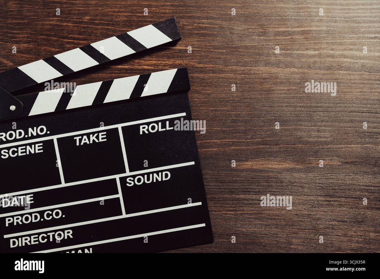 Foto d'epoca di un clapper cinematografico su sfondo in legno, primo piano, vista dall'alto, spazio copia Foto Stock
