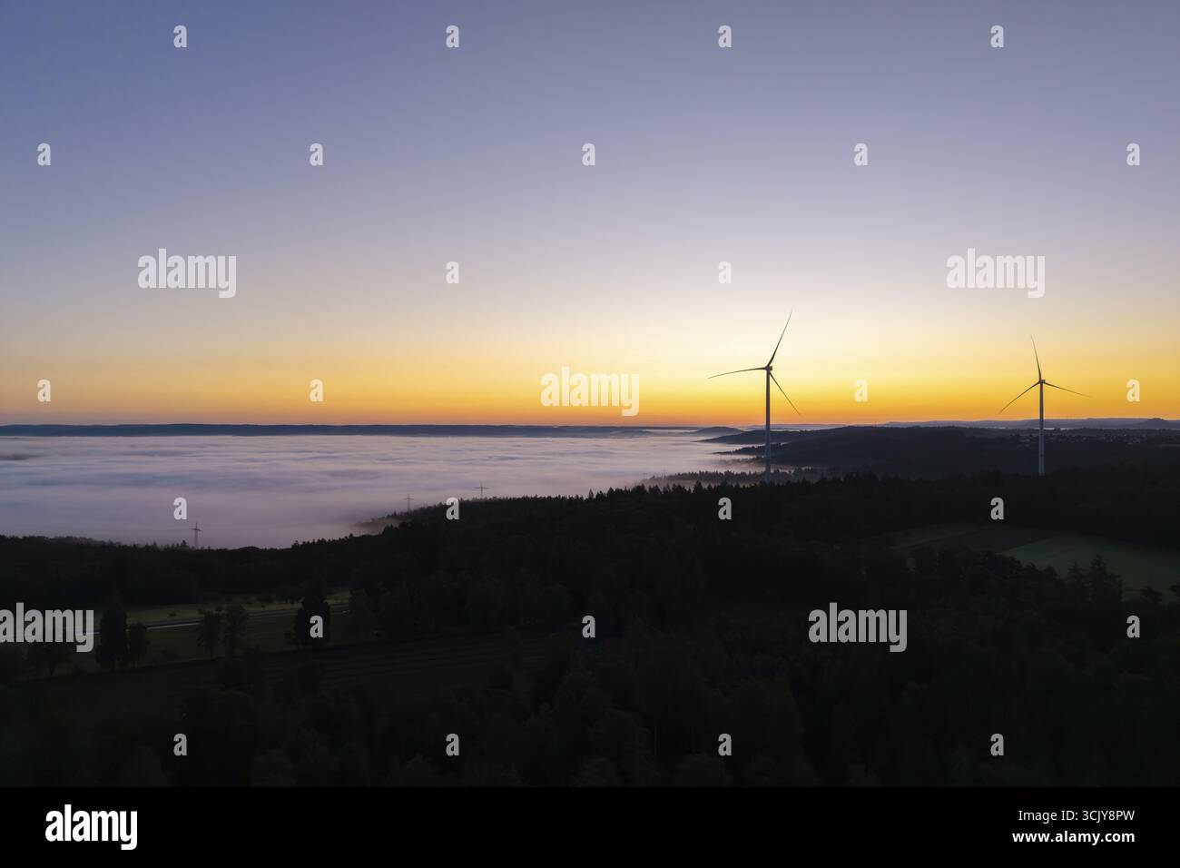 Cielo mattutino più scuro con turbine eoliche e nebbia in primo piano, vicino a Schorndorf, Remstal, Rems-Murr-Kreis, Baden-Wuerttemberg, Germania Foto Stock