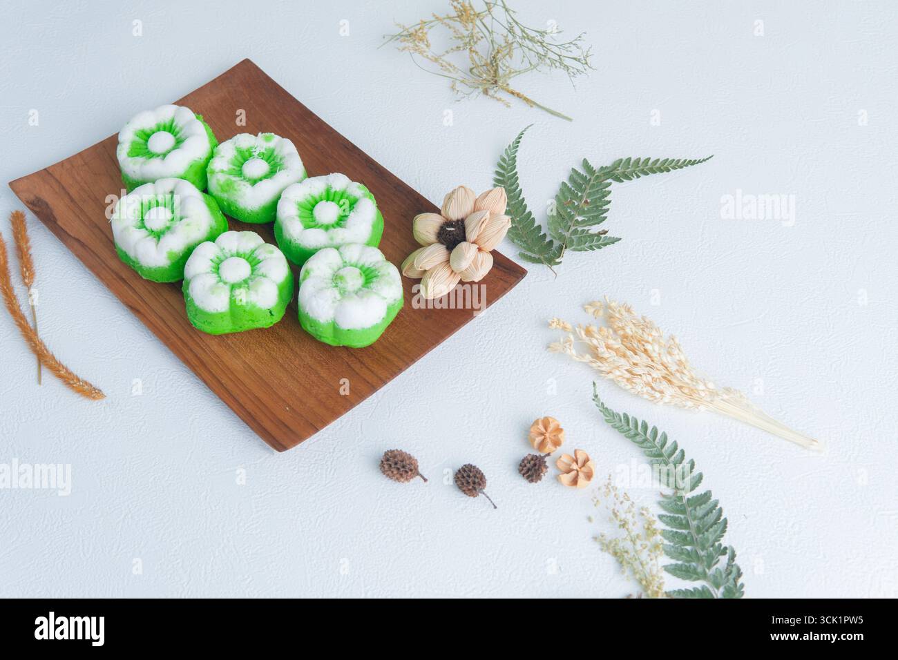 Putu ayu con torte al vapore indonesiane preparate al momento e ricoperte di cocco su un tavolo di legno, tradizionale spuntino fatto in casa. Foto Stock