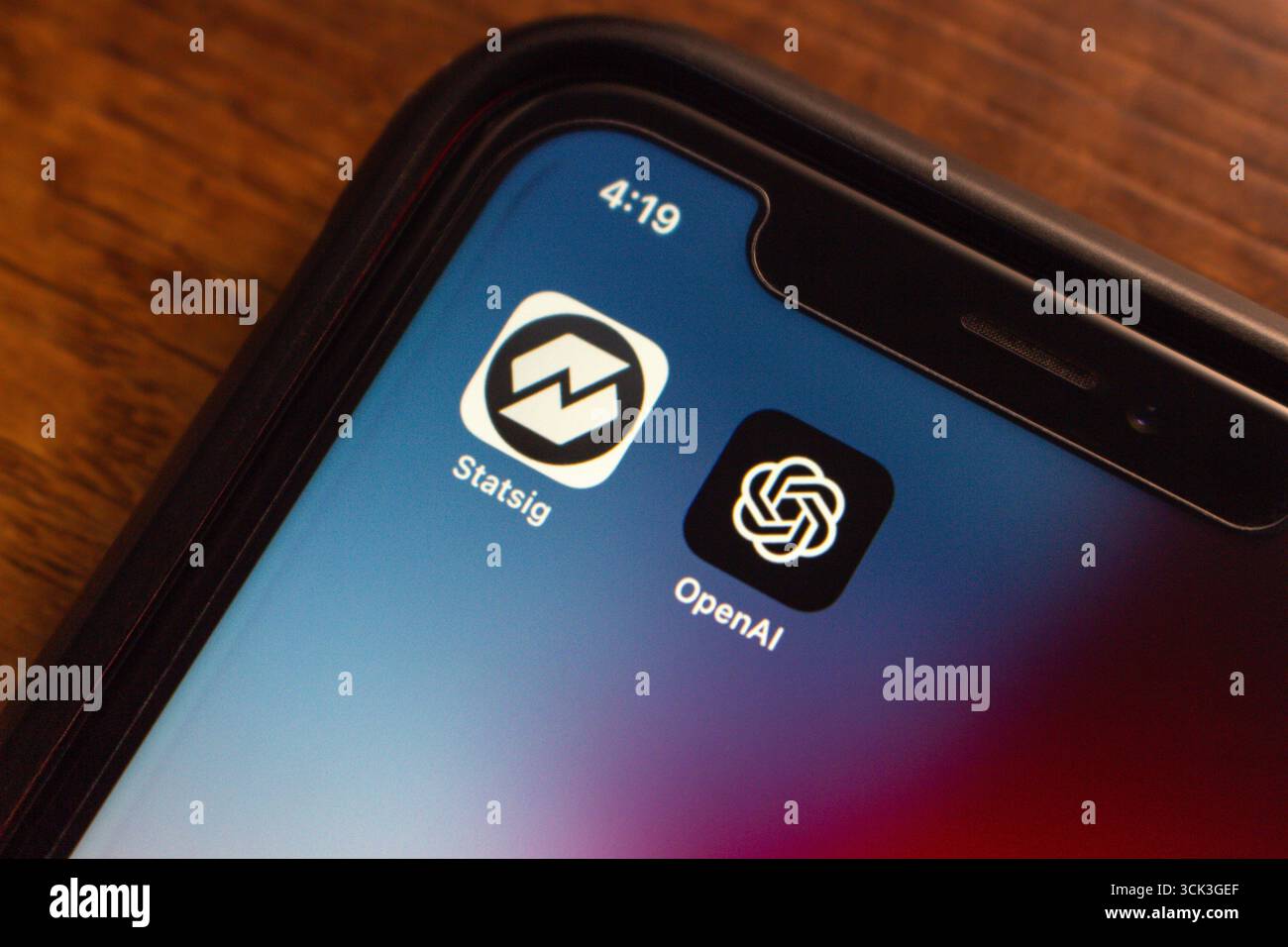 Vista ravvicinata di uno smartphone con icone Statsig e OpenAI, che rappresenta la recente acquisizione e partnership strategica. Foto Stock