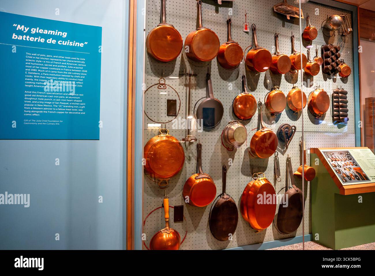 Smithsonian National Museum of American History Julia Childs Kitchen Copper Cookware Washington DC // WASHINGTON DC — la mostra Julia Child's Kitchen presso lo Smithsonian National Museum of American History espone una parete di pentole, padelle e strumenti di rame della sua collezione personale. Questo spettacolo riflette lo stile eclettico del bambino, mescolando influenze culinarie francesi e americane. La maggior parte delle pentole in rame furono acquistate in Francia tra il 1948 e il 1980, spesso dal rinomato negozio di cucina E. Dehillerin. I vasi, molti rivestiti di stagno, sono noti per la loro uniforme conduttività termica, caratteristica Foto Stock Smithsonian National Museum of American History Julia Childs Kitchen Copper Cookware Washington DC // WASHINGTON DC — la mostra Julia Child's Kitchen presso lo Smithsonian National Museum of American History espone una parete di pentole, padelle e strumenti di rame della sua collezione personale. Questo spettacolo riflette lo stile eclettico del bambino, mescolando influenze culinarie francesi e americane. La maggior parte delle pentole in rame furono acquistate in Francia tra il 1948 e il 1980, spesso dal rinomato negozio di cucina E. Dehillerin. I vasi, molti rivestiti di stagno, sono noti per la loro uniforme conduttività termica, caratteristica Foto Stock