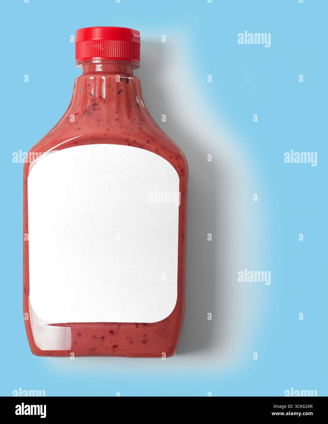 Una bottiglia di salsa con un tappo rosso e un'etichetta vuota, pronta per il branding o per l'uso personale. Foto Stock