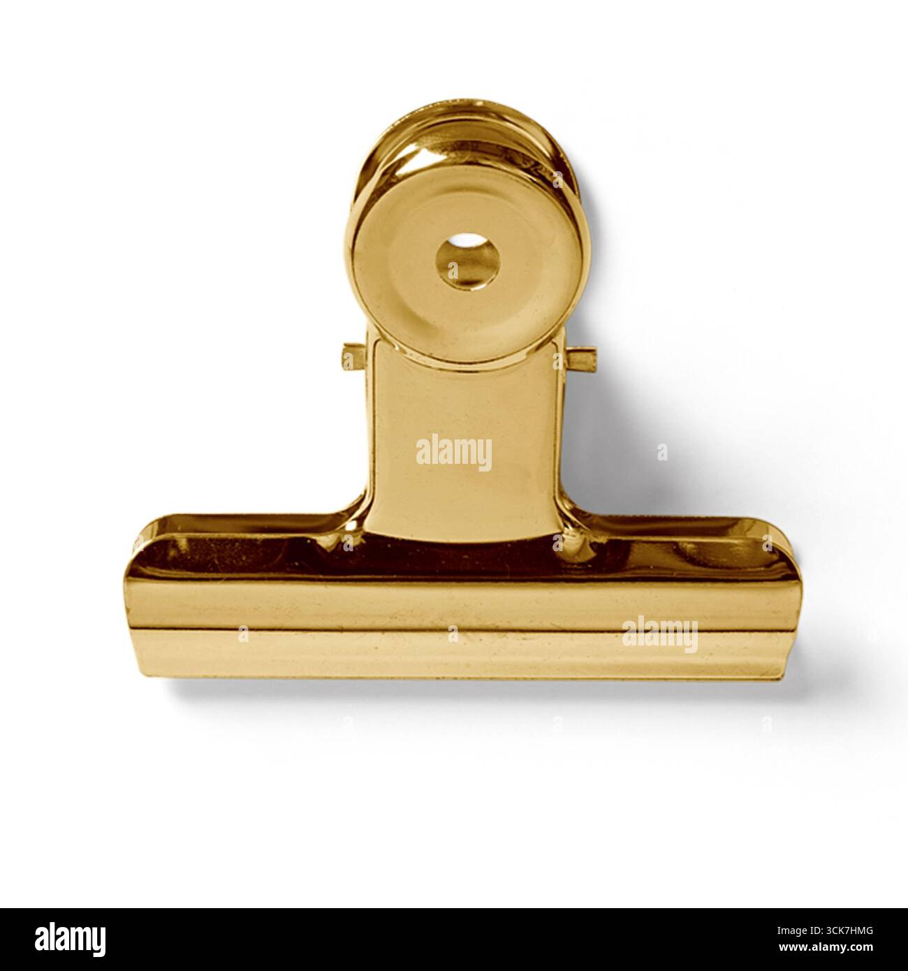 Una graffetta in oro lucido utilizzata per tenere insieme i documenti. Foto Stock