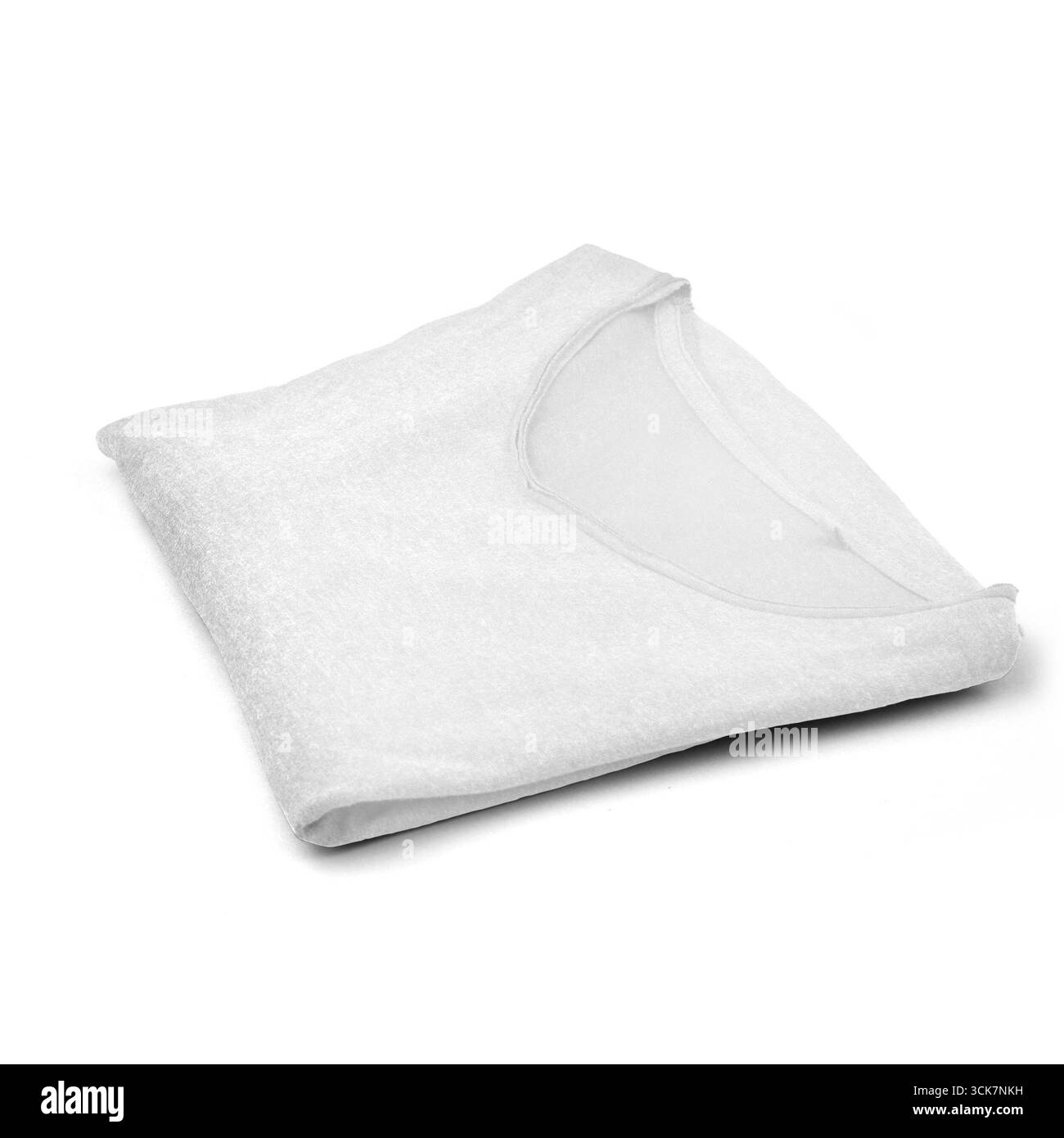 Una t-shirt bianca piegata in modo ordinato, che mette in risalto la semplicità e l'abbigliamento di tutti i giorni. Foto Stock