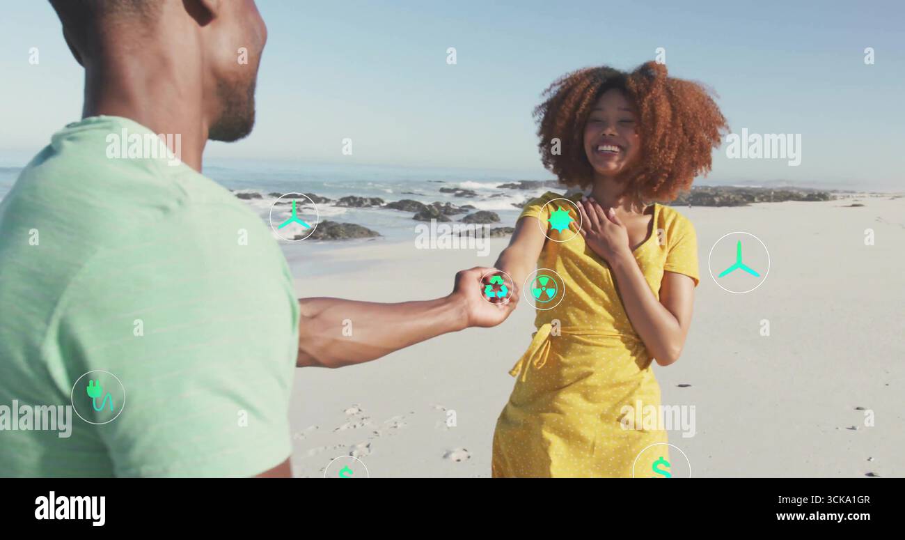 Uomo che offre una sfera verde brillante di riciclaggio alla donna in abito giallo sulla spiaggia, con icone ecologiche Foto Stock